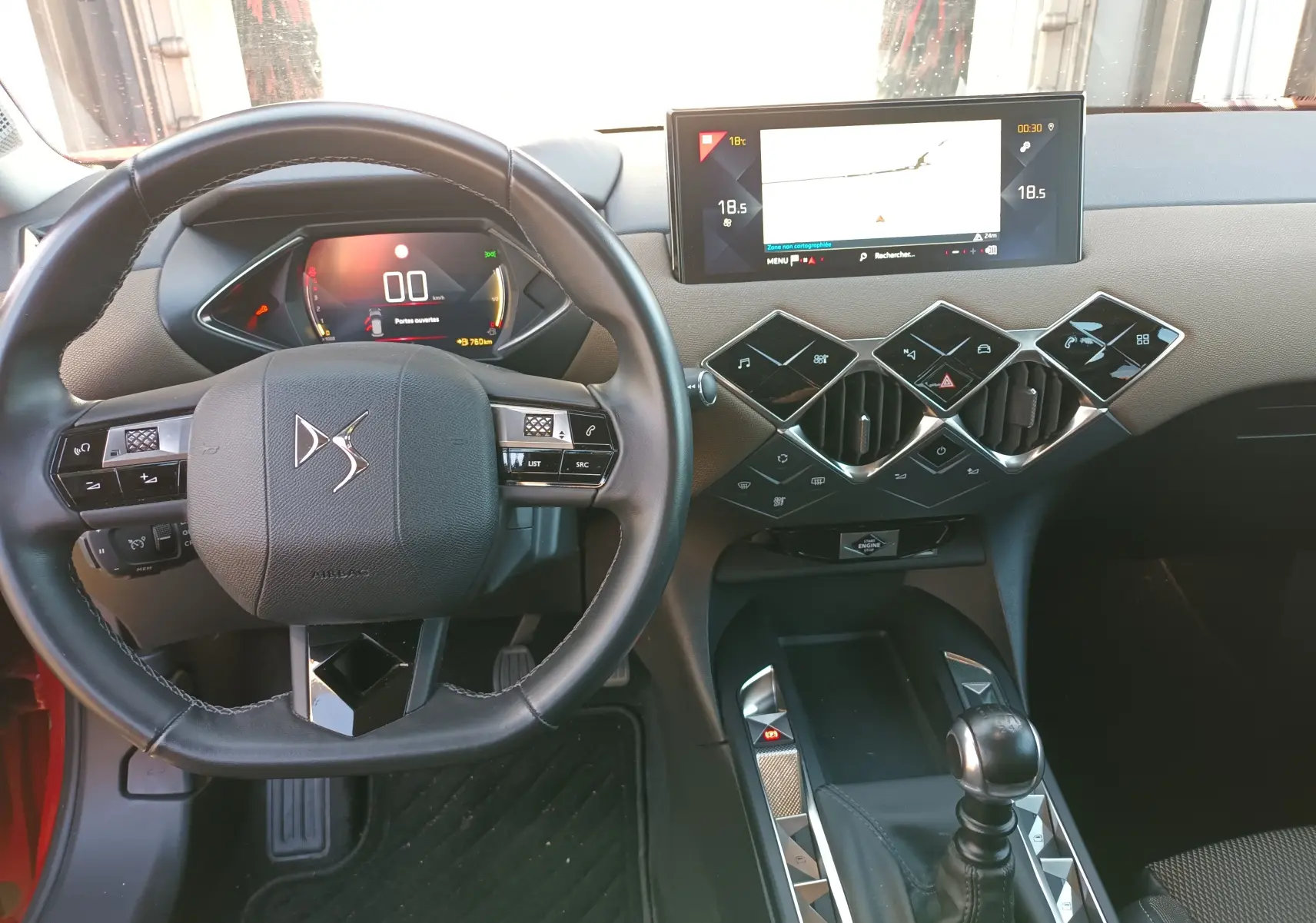 Vue intérieure du tableau de bord et volant DS3 Crossback avec écran tactile et commandes modernes, volant cuir noir.