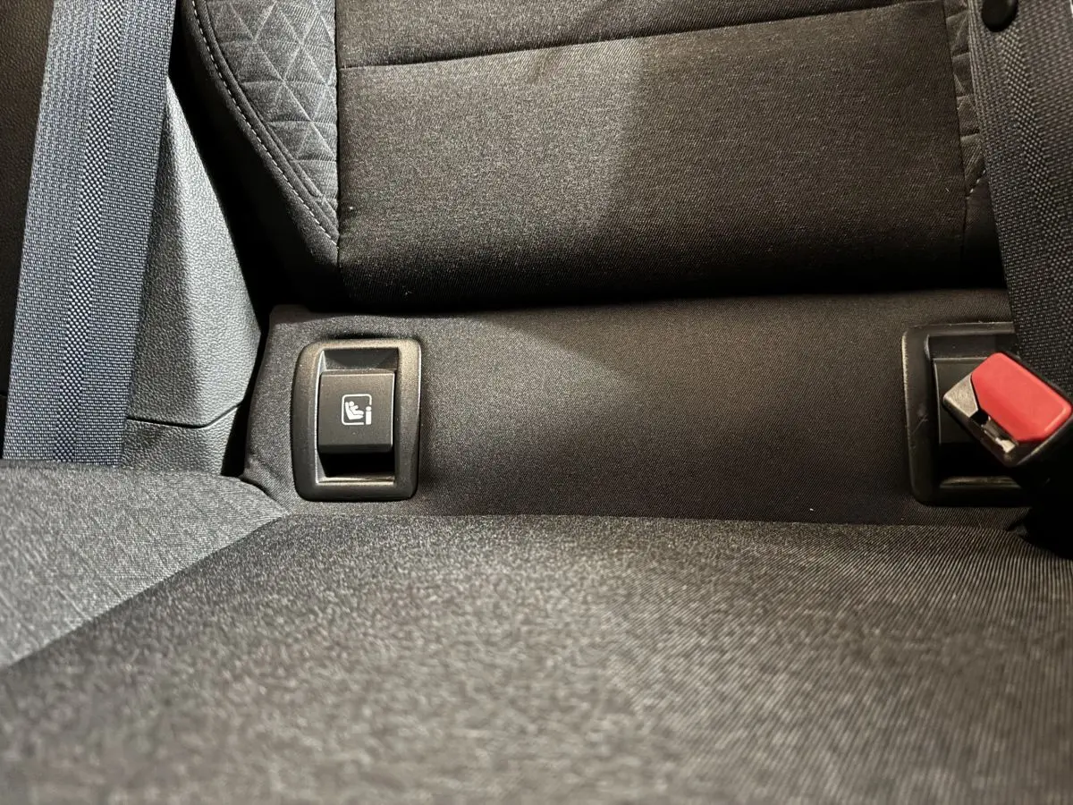 Gros plan sur l’ancrage Isofix arrière de la banquette noire d’une Renault Clio Business TCe 100 blanche de 2020.
