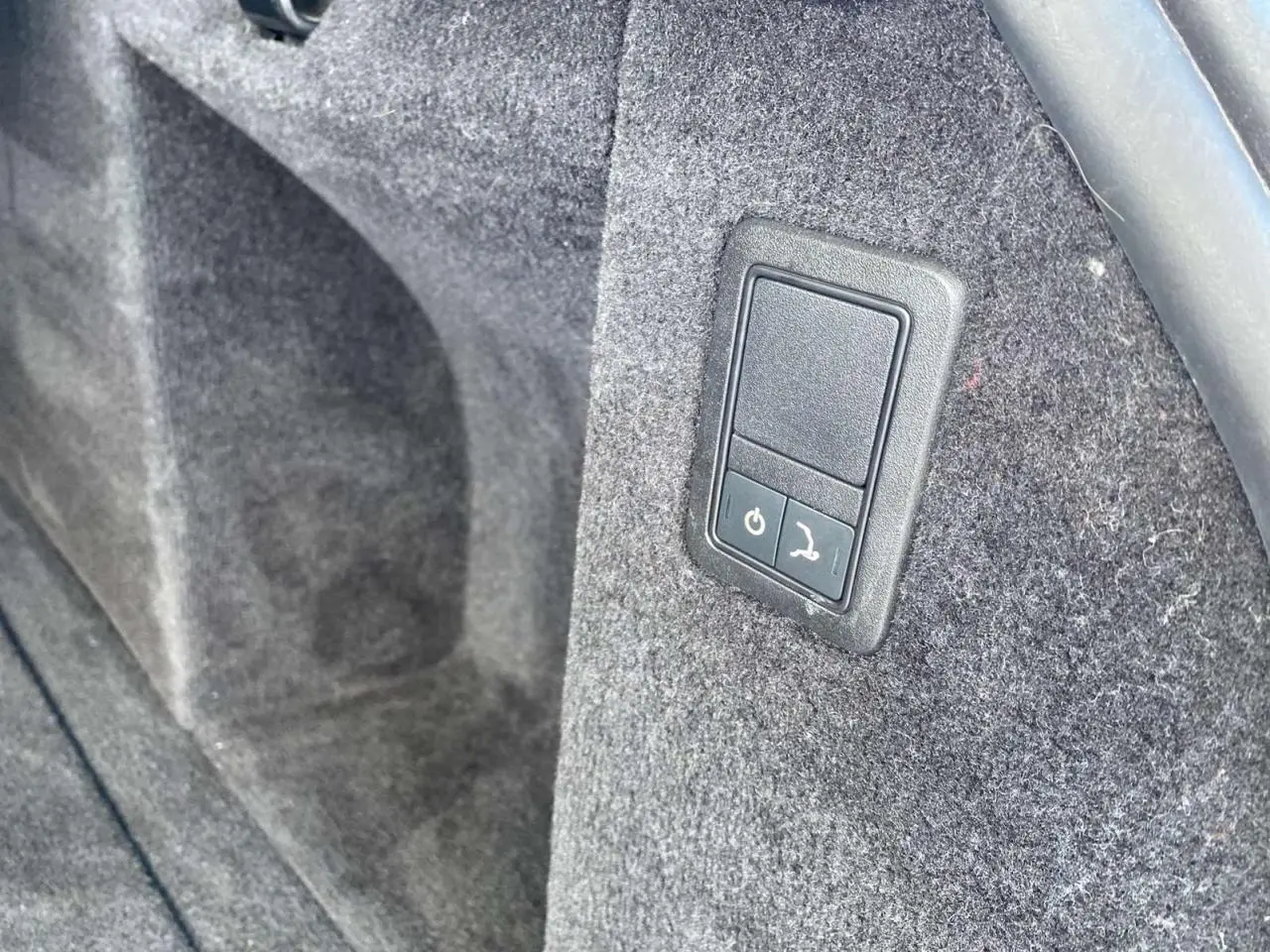 Bouton électrique de déploiement du crochet d'attelage dans le coffre du Range Rover Sport SVR noir 2016.