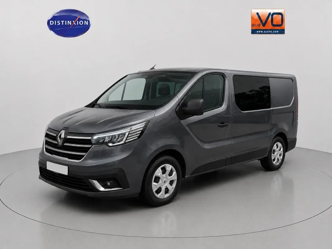 Renault Trafic Fourgon gris foncé vu en 3/4 avant droit, avec vitres surteintées et porte latérale visible.