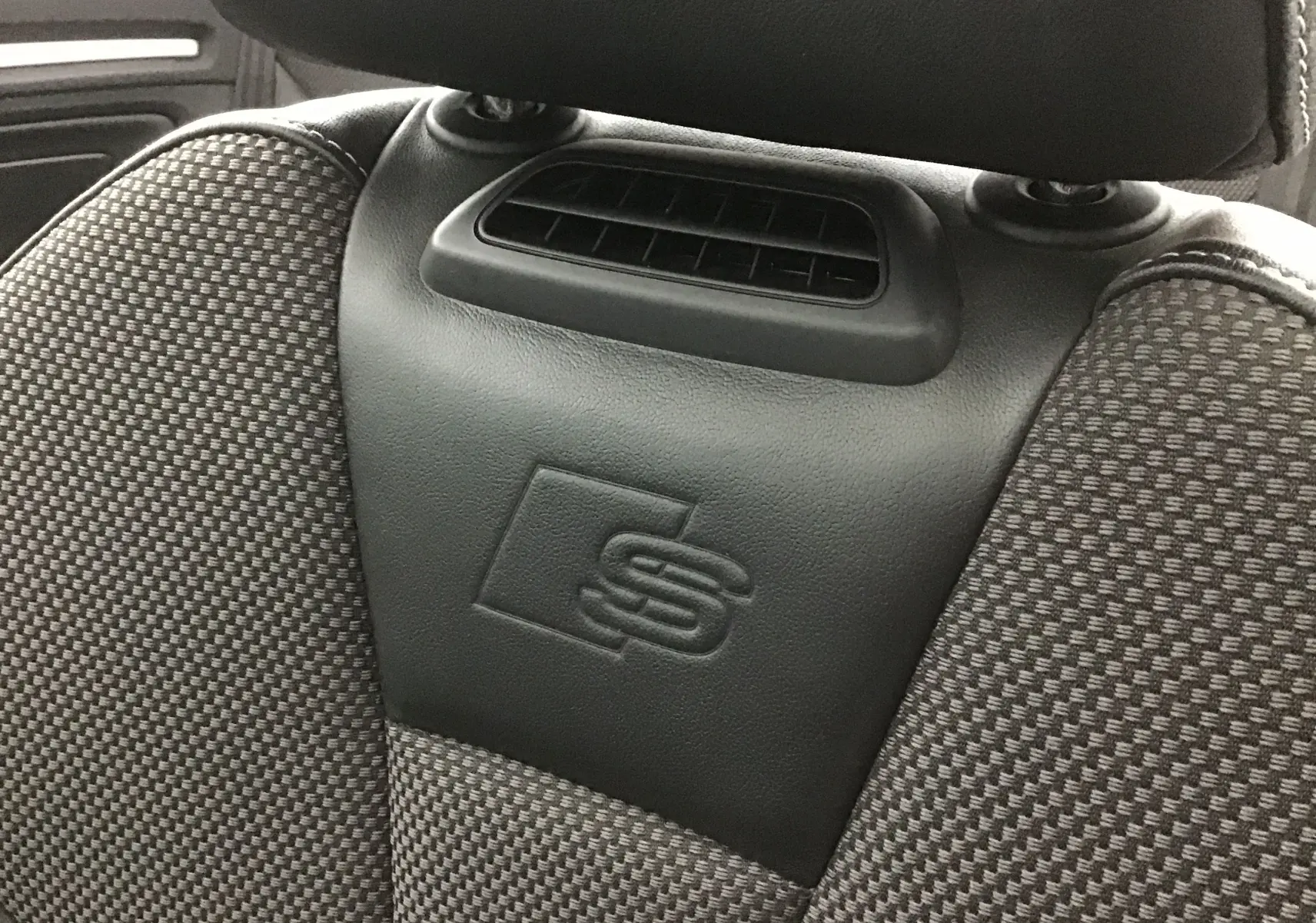 Détail du siège avant de l'Audi A3 Cabriolet noir 2020, mettant en valeur le logo S embossé sur le cuir.