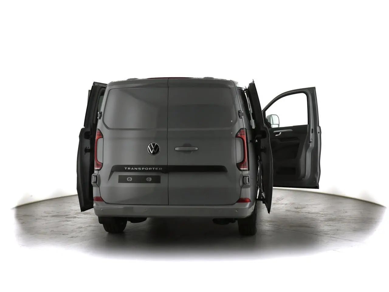 Vue arrière du Volkswagen Transporter gris Stone 2025 avec portes arrière et porte passager avant ouvertes.