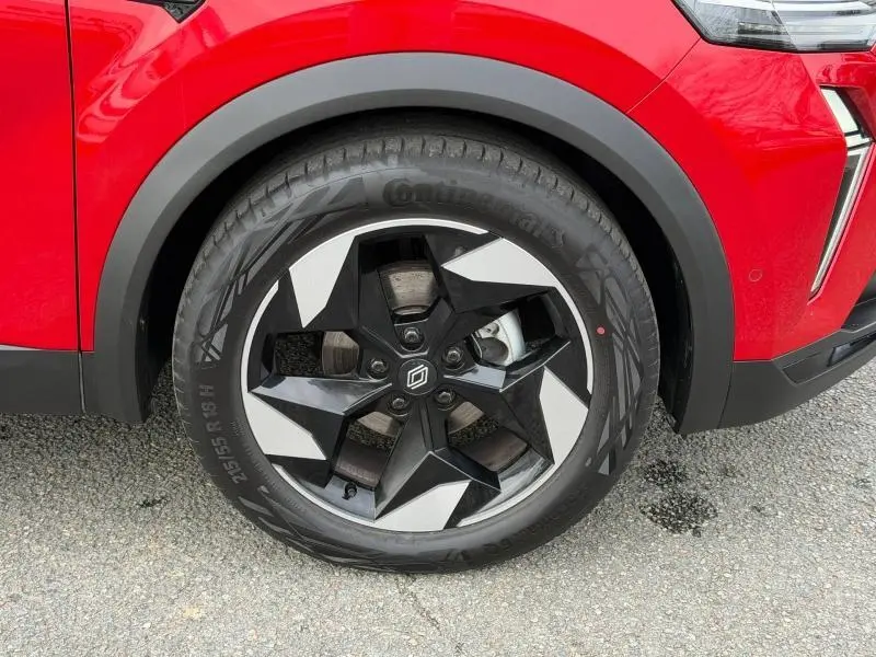 Gros plan sur la roue avant droite du Renault Captur Rouge Flamme 2025 avec jante noire et argentée au design géométrique.