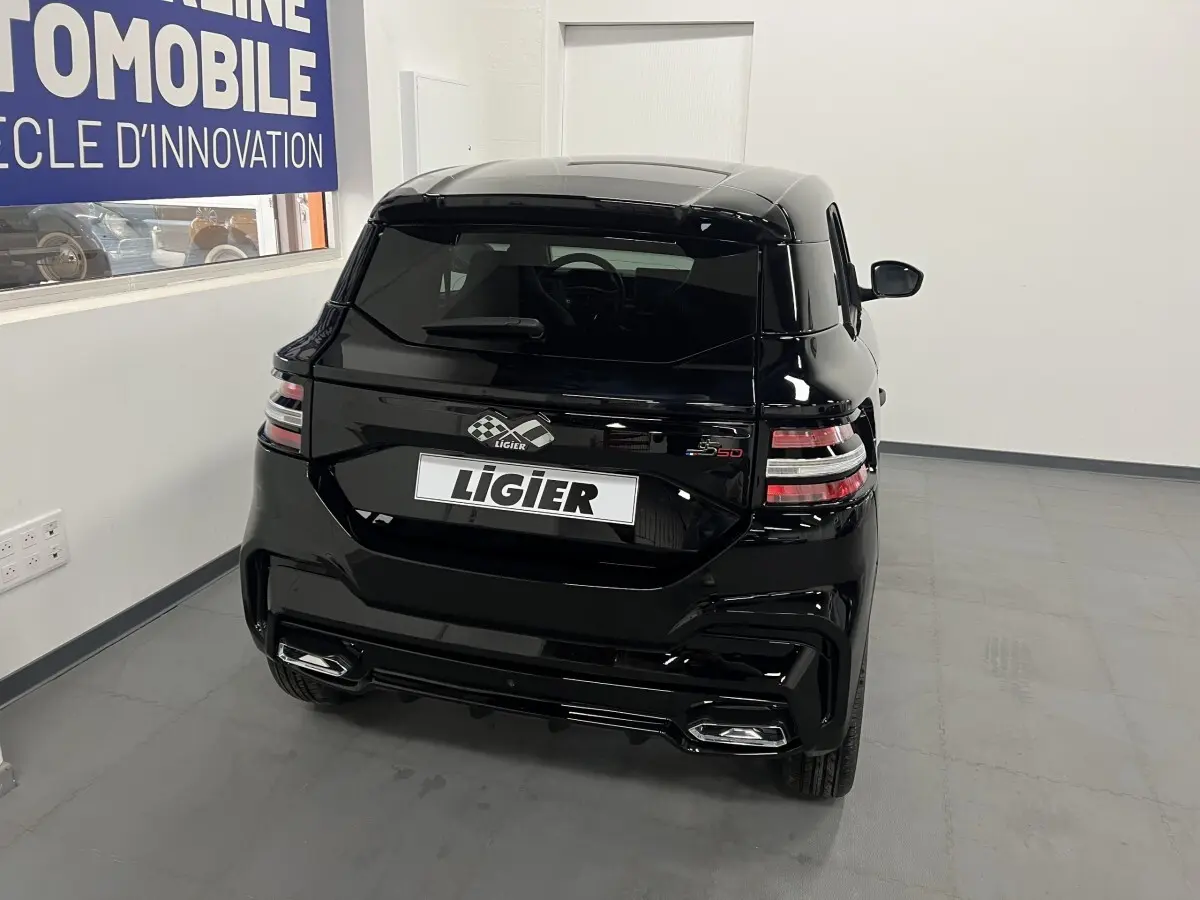 Vue 3/4 arrière d'une Ligier JS50 noire 2026 avec feux LED et double sortie d'échappement intégrée.