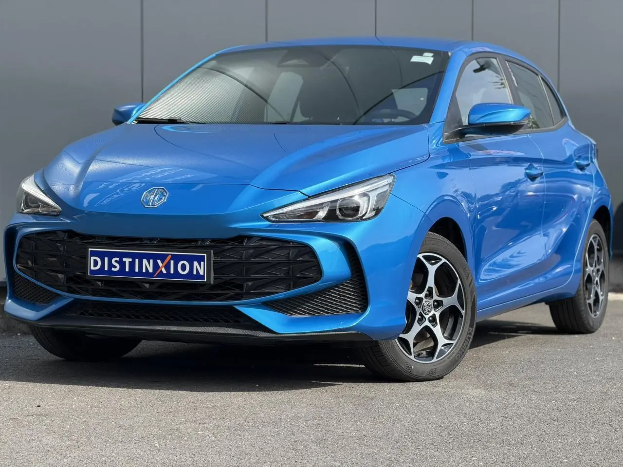 MG3 1.5 Hybrid+ 195 Comfort bleu Como en 3/4 avant droit avec calandre noire et jantes alliage 16 pouces.