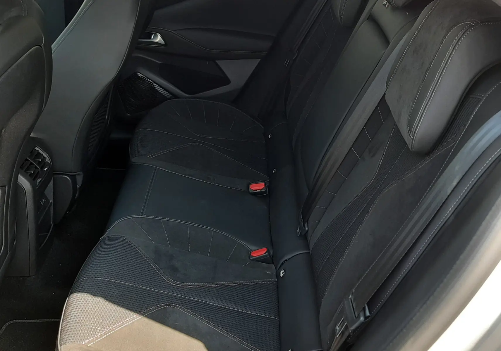 Vue intérieure côté droit des sièges arrière noirs en cuir et alcantara du DS4 2024 couleur Cristal Pearl.