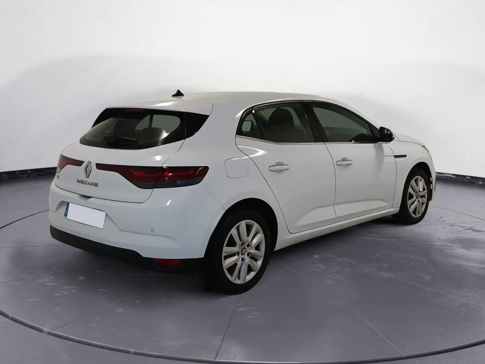 Renault Mégane IV blanche vue 3/4 arrière droit, avec feux arrière LED et caméra de recul visible.