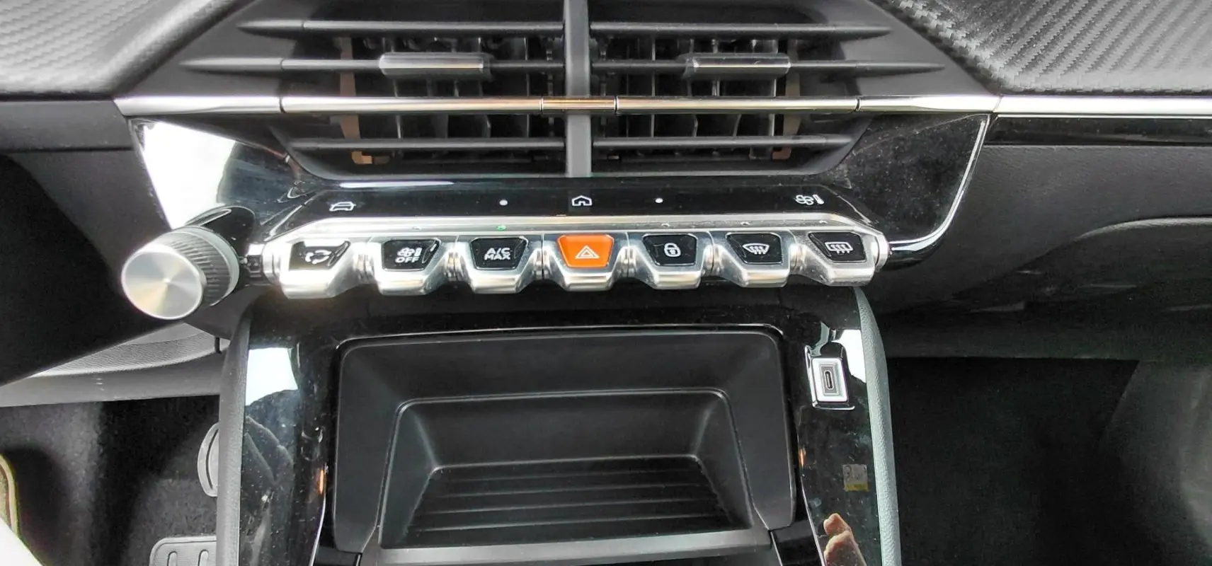 Vue rapprochée de la console centrale du Peugeot 2008 Hybrid 145 e-DCS6 Style 2025, boutons piano noirs et chrome.
