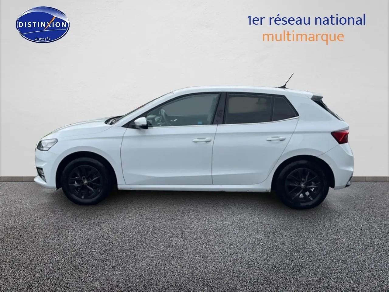 Vue de profil côté gauche d'une Skoda Fabia blanche avec jantes noires sur fond neutre.