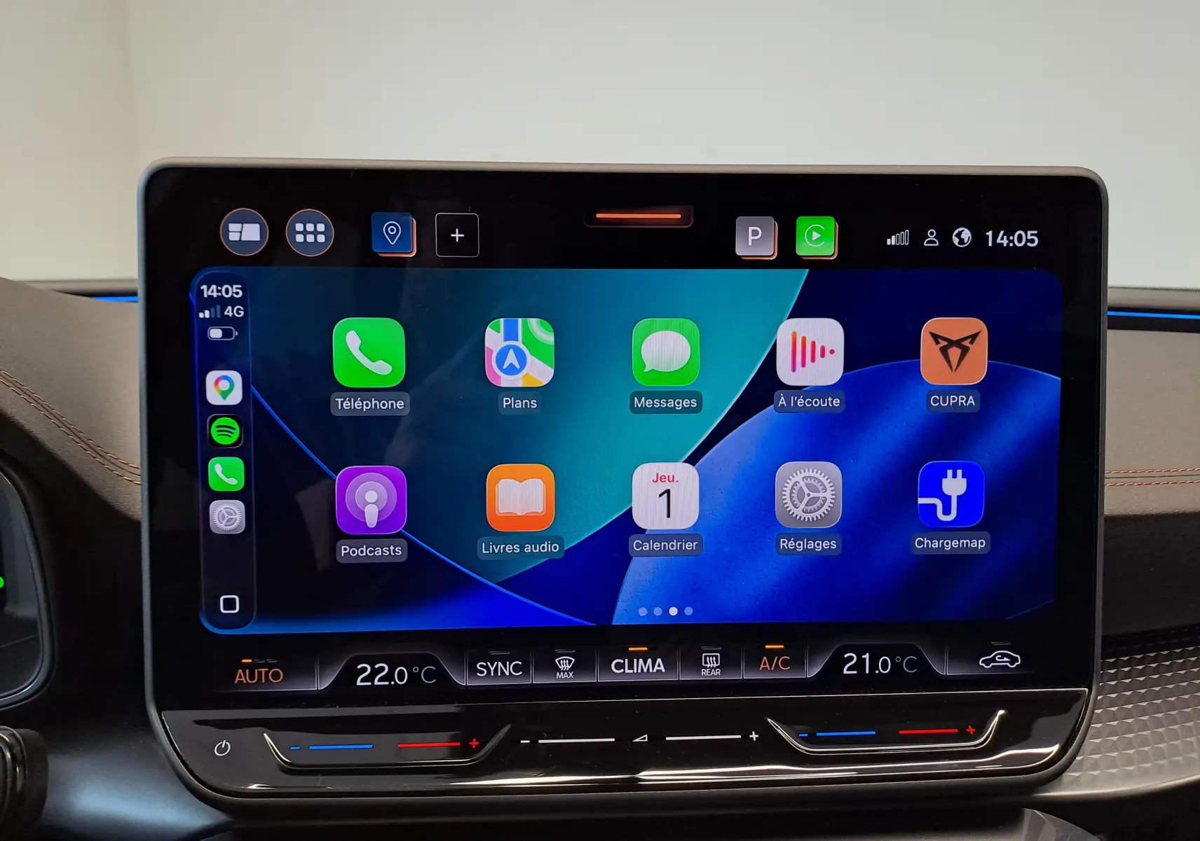 Écran tactile central du tableau de bord du CUPRA LEON ST 2025, affichant Apple CarPlay et commandes climatisation.