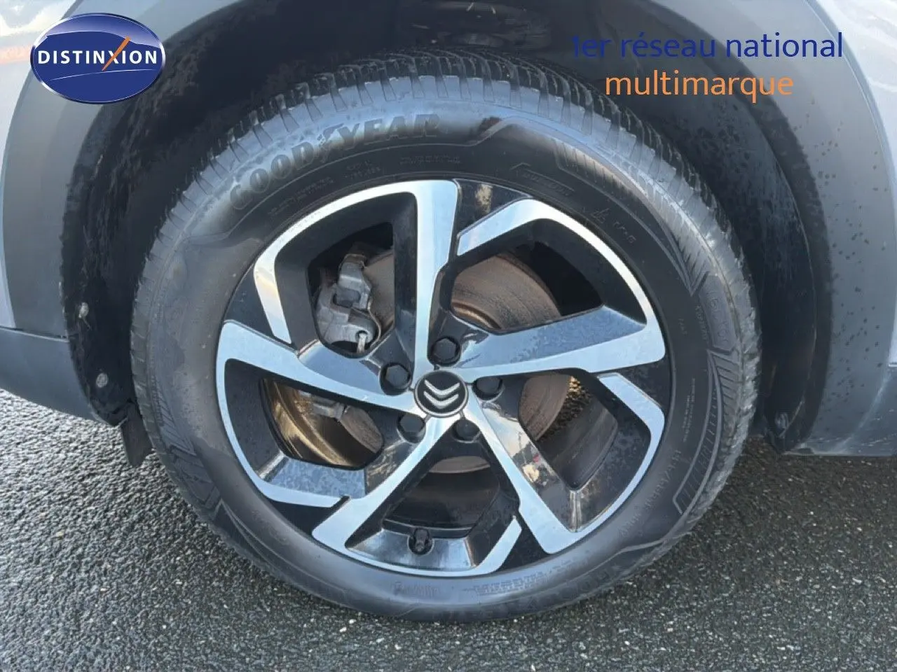 Gros plan sur la roue avant gauche du Citroën C5 Aircross gris Artense métal avec jante alliage bicolore.