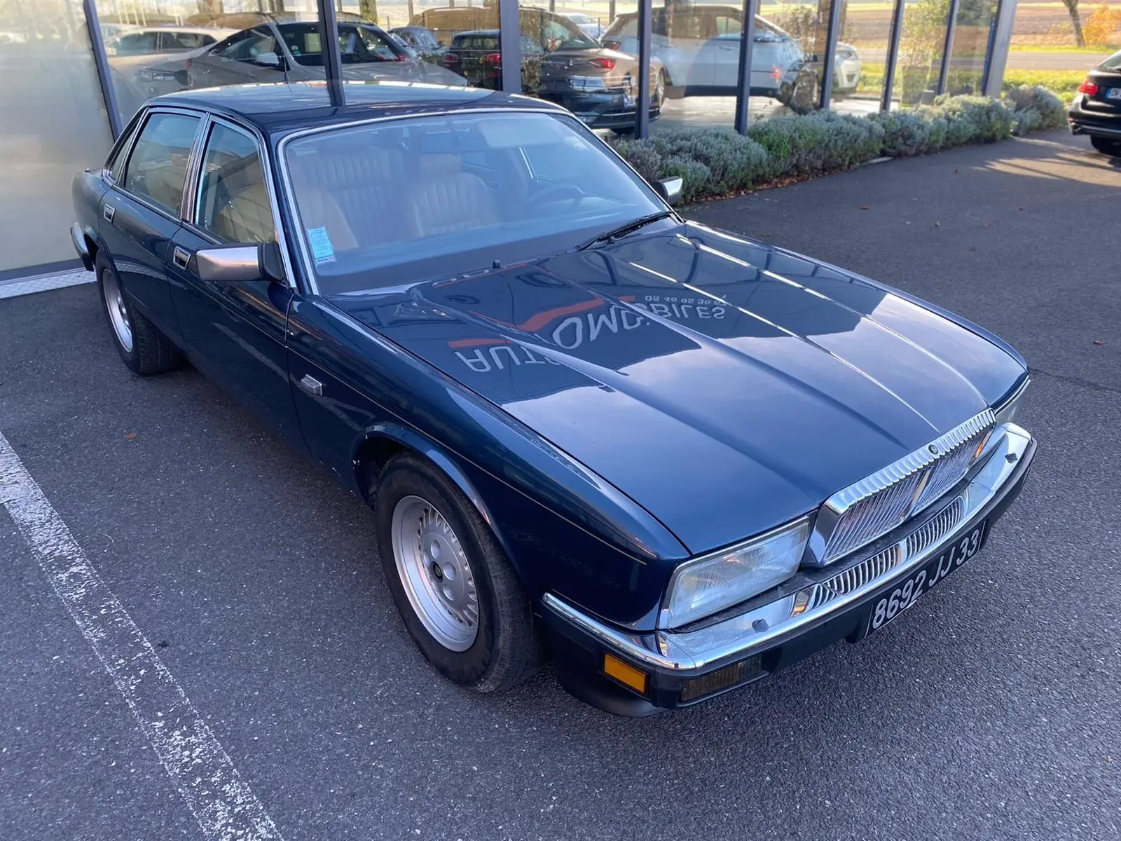 Jaguar XJ6 3.6 Sovereign bleu vue 3/4 avant gauche, avec calandre chromée et jantes alliage d'origine.