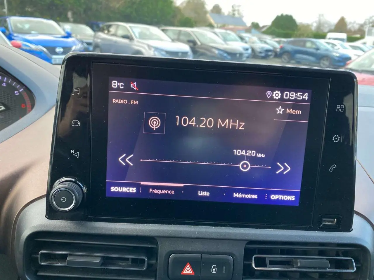 Écran tactile central de la Peugeot Rifter GT bleu, affichant la radio FM à 104,20 MHz, vue intérieure.