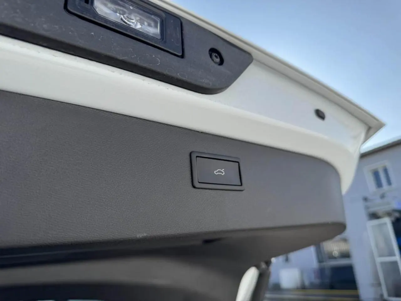 Bouton d'ouverture électrique du coffre sur la partie intérieure du hayon d'un CUPRA Formentor blanc nacré.