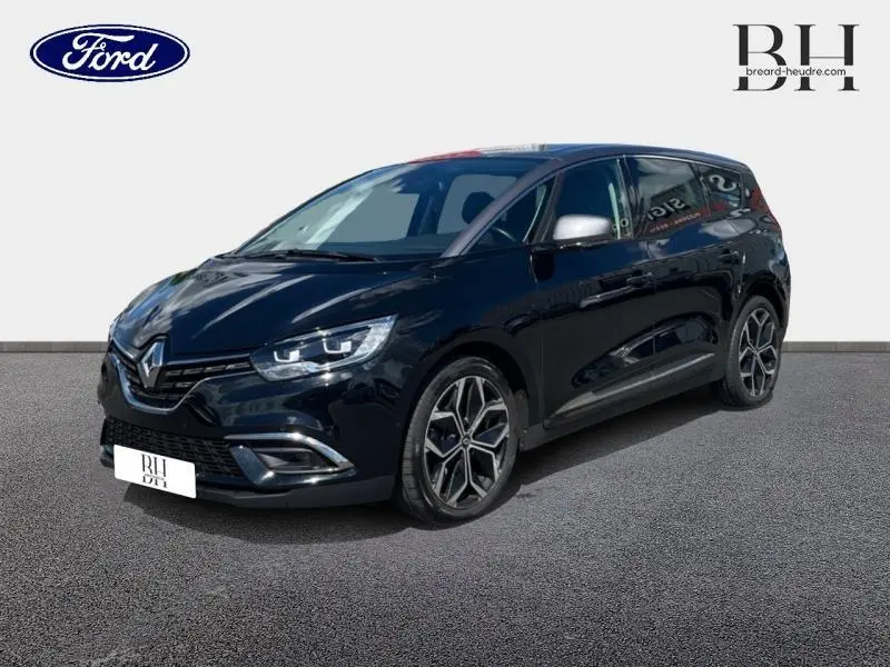 Renault Grand Scenic noir étoilé en 3/4 avant droit, avec jantes alliage 20 pouces et feux LED distinctifs.
