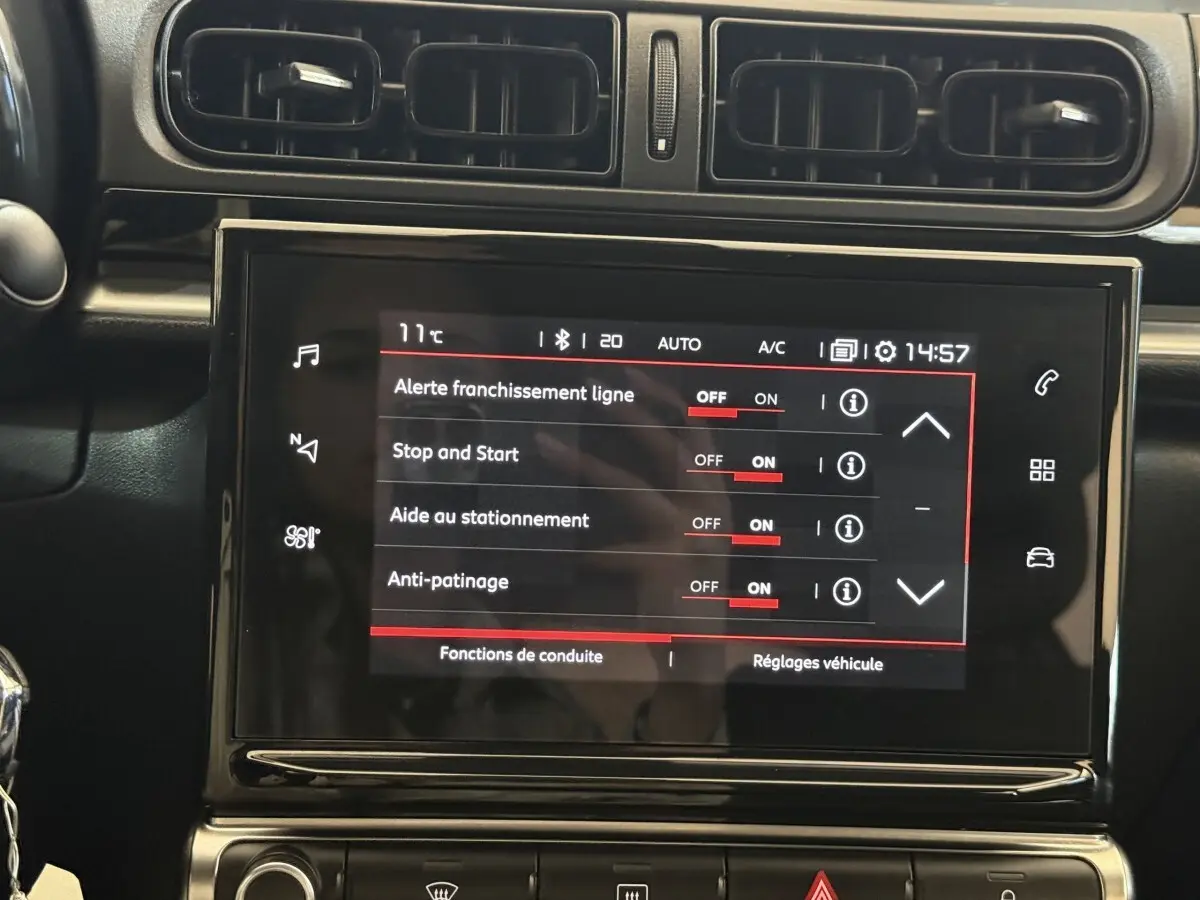 Vue rapprochée de l'écran tactile central de la Citroën C3 blanc, affichant les réglages d'aide à la conduite.