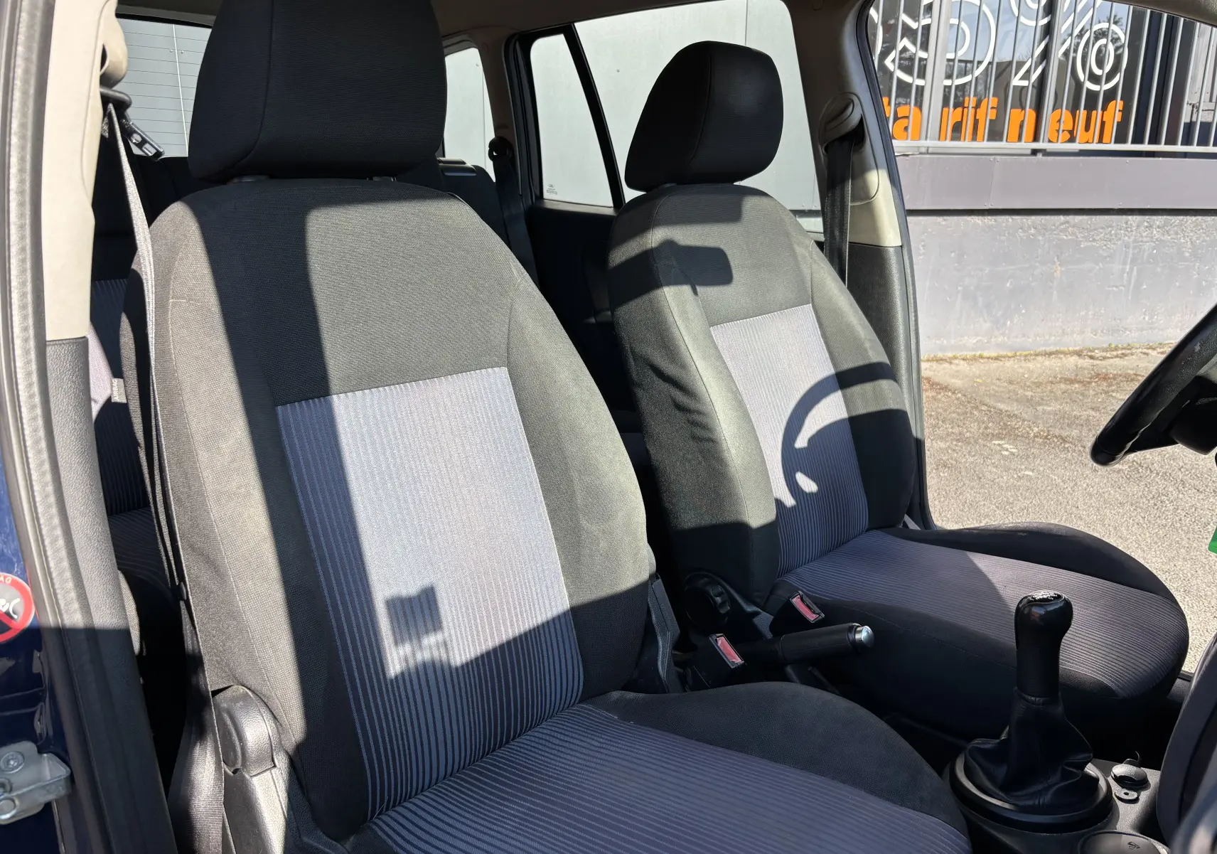 Intérieur avant de la Ford Fusion 2009 bleu, vue côté droit montrant les sièges tissu bicolore et levier de vitesse manuel.