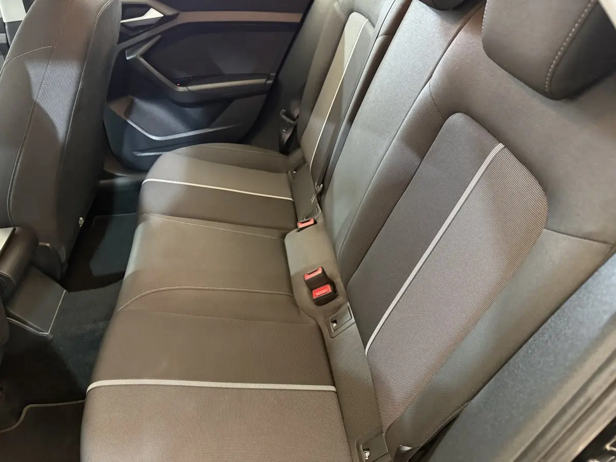 Vue latérale des sièges arrière noirs avec surpiqûres claires de l'Audi A1 Business Line 2021.