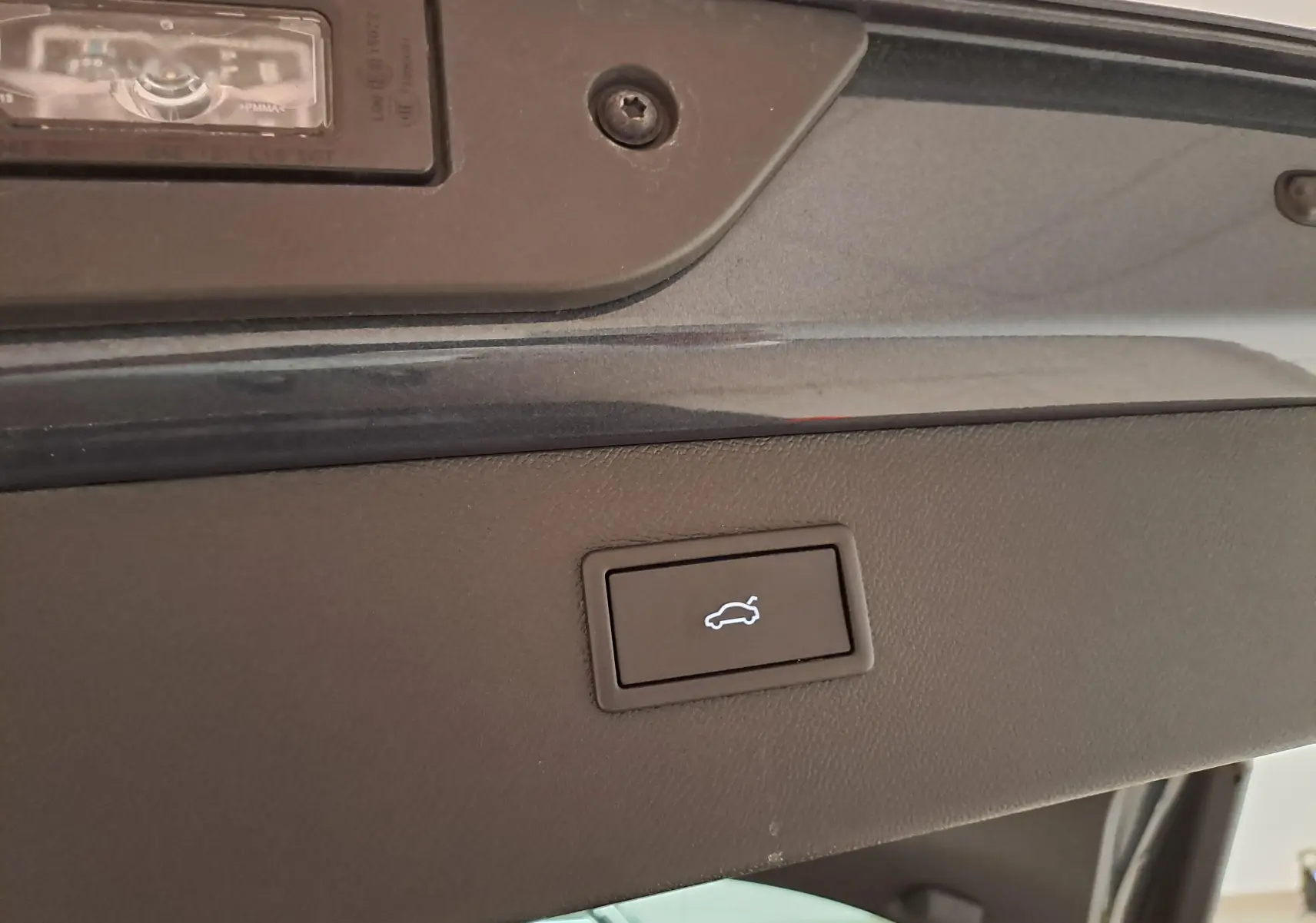 Bouton d'ouverture électrique du hayon sur la partie intérieure du coffre d'un CUPRA Formentor gris magnétique.