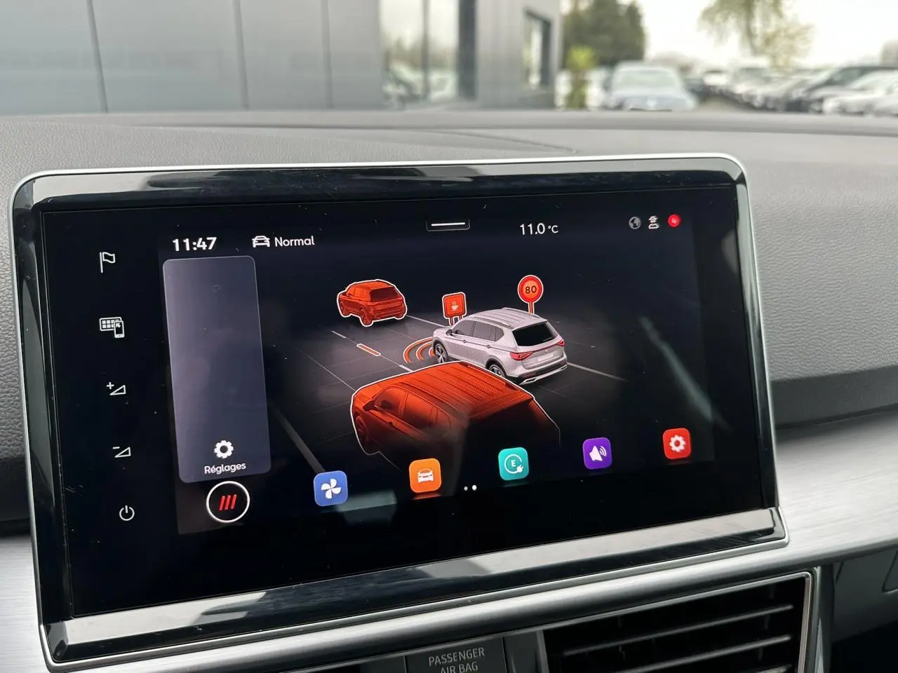 Écran tactile intérieur montrant l'assistance à la conduite avec vue 3D des véhicules et panneaux de signalisation