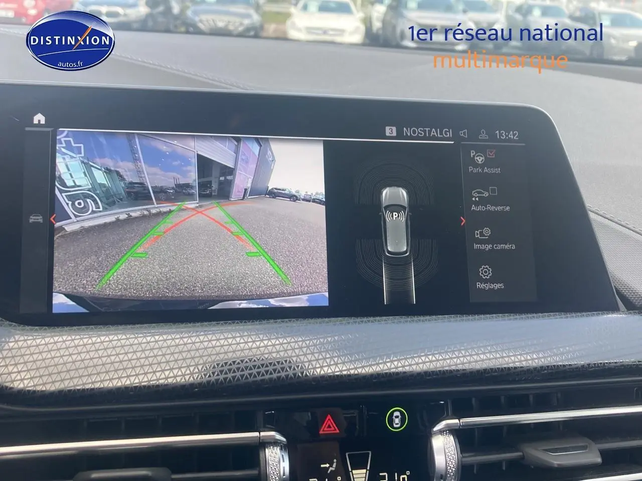 Écran central de BMW Série 1 noir 2023 montrant la caméra de recul avec guidage dynamique en ville.