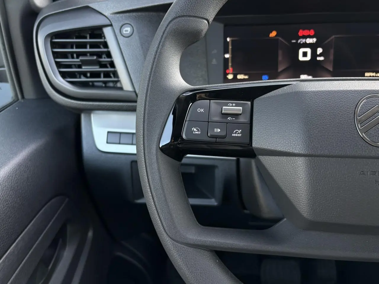 Gros plan sur le volant noir du Citroën Jumpy 2025 avec commandes intégrées côté gauche et tableau de bord numérique.