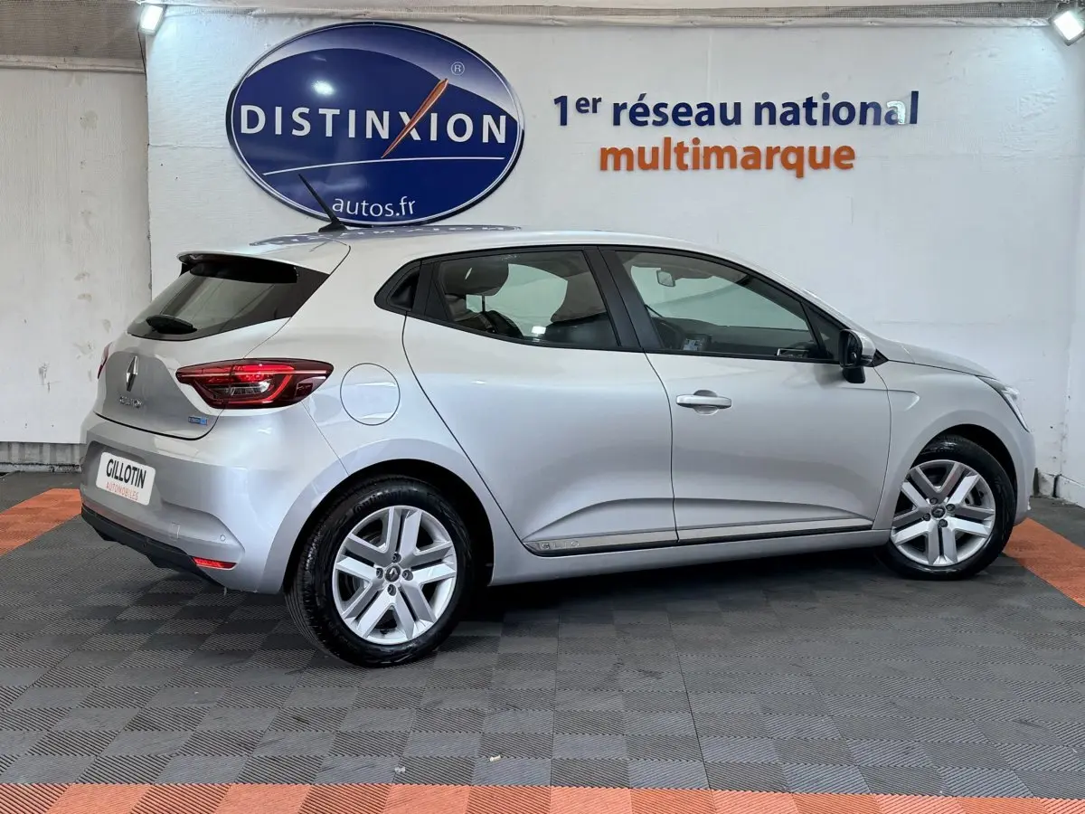 Vue latérale droite d'une Renault Clio Business E-Tech hybride gris clair, avec jantes alliage et feux arrière LED visibles.