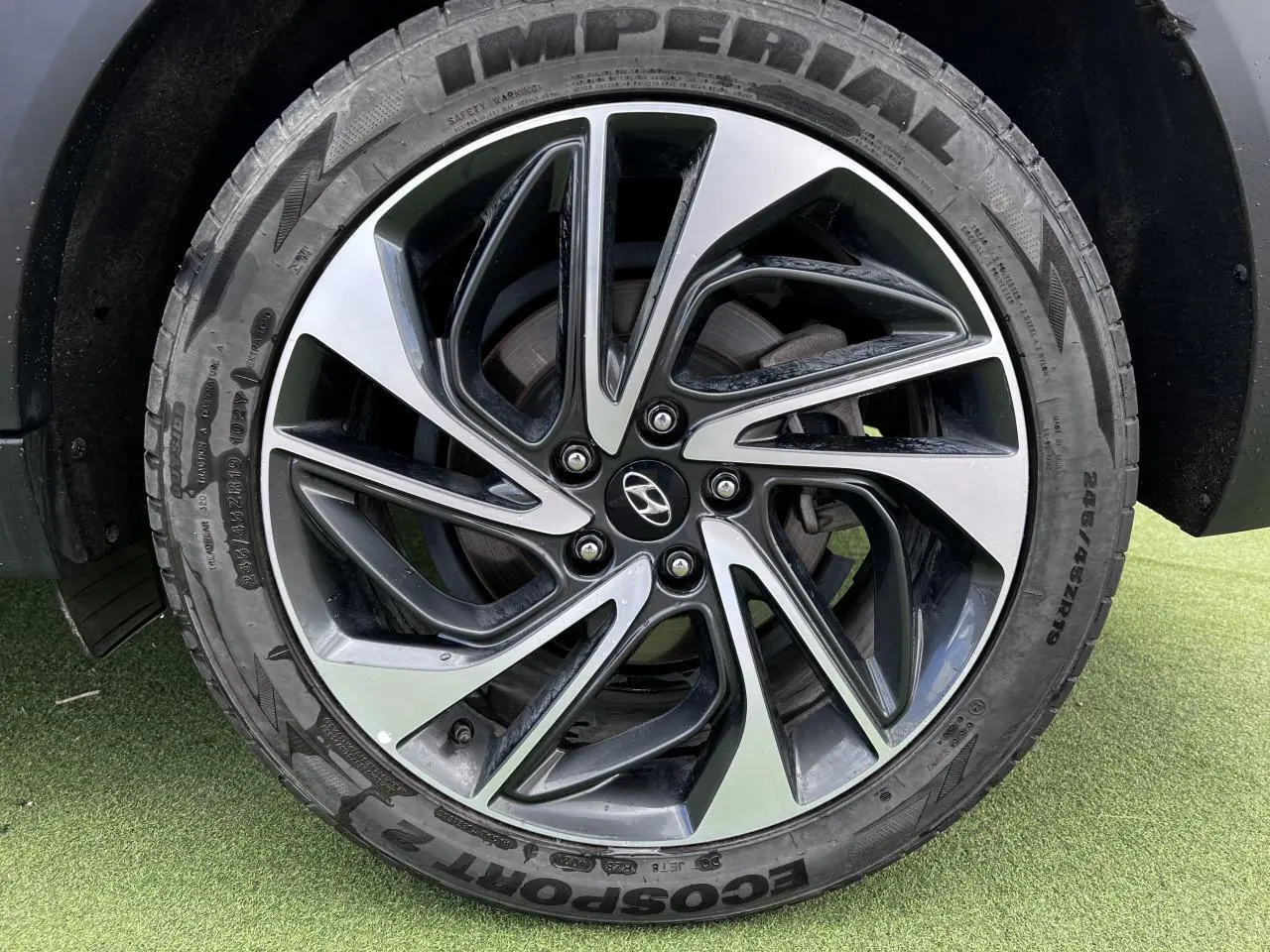 Gros plan sur la jante alliage 17'' bicolore et le pneu Imperial du Hyundai Tucson rouge métallisé côté droit.