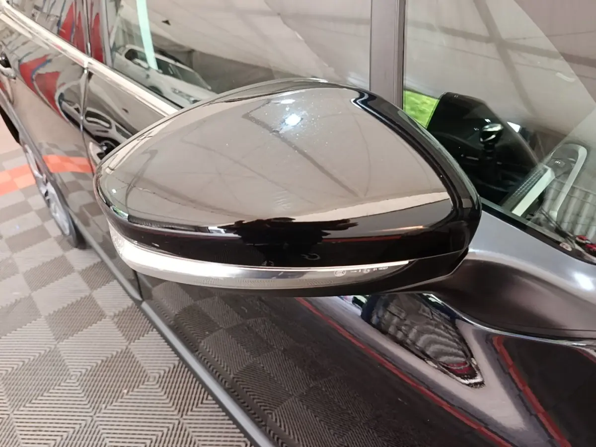 Rétroviseur droit noir brillant de Peugeot 2008 2019, reflet de l'intérieur et carrosserie noire visible.
