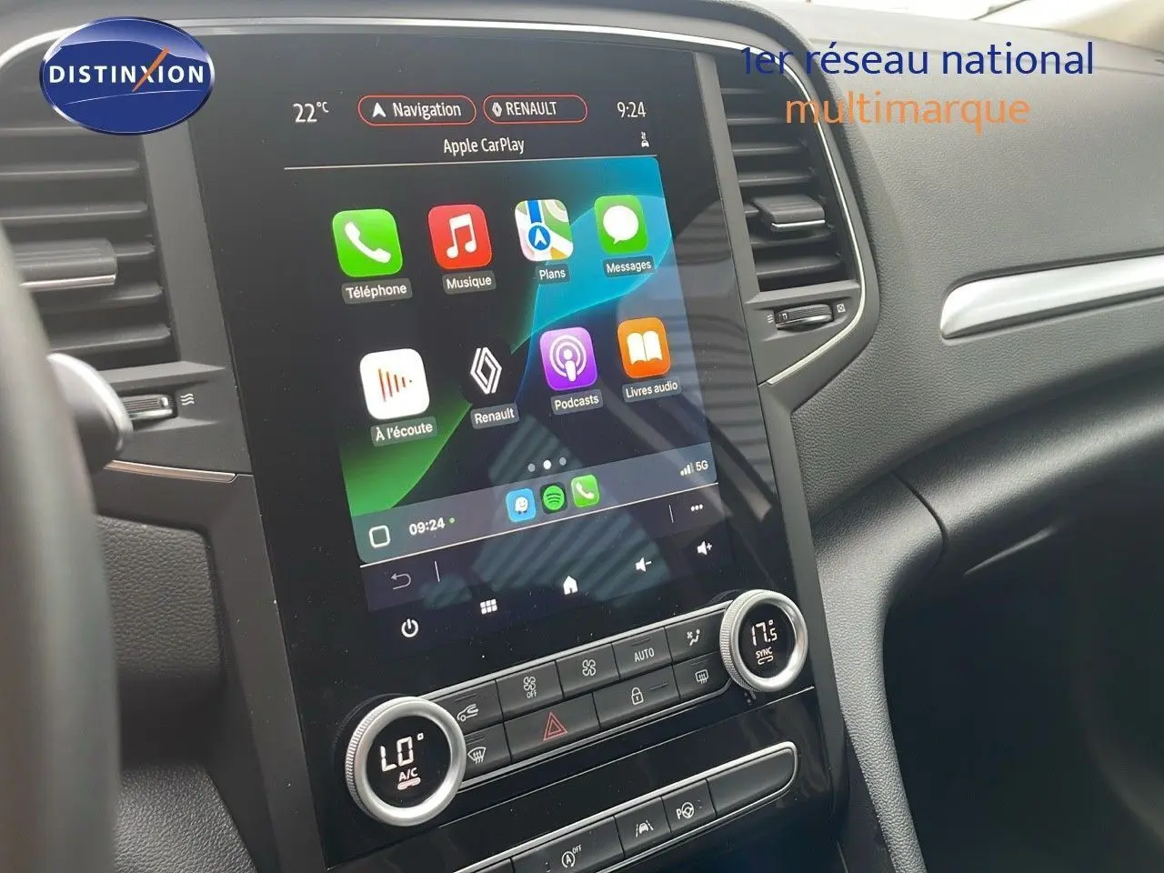 Vue rapprochée de la console centrale tactile du Renault Mégane Break gris Highland Metal, affichant Apple CarPlay.