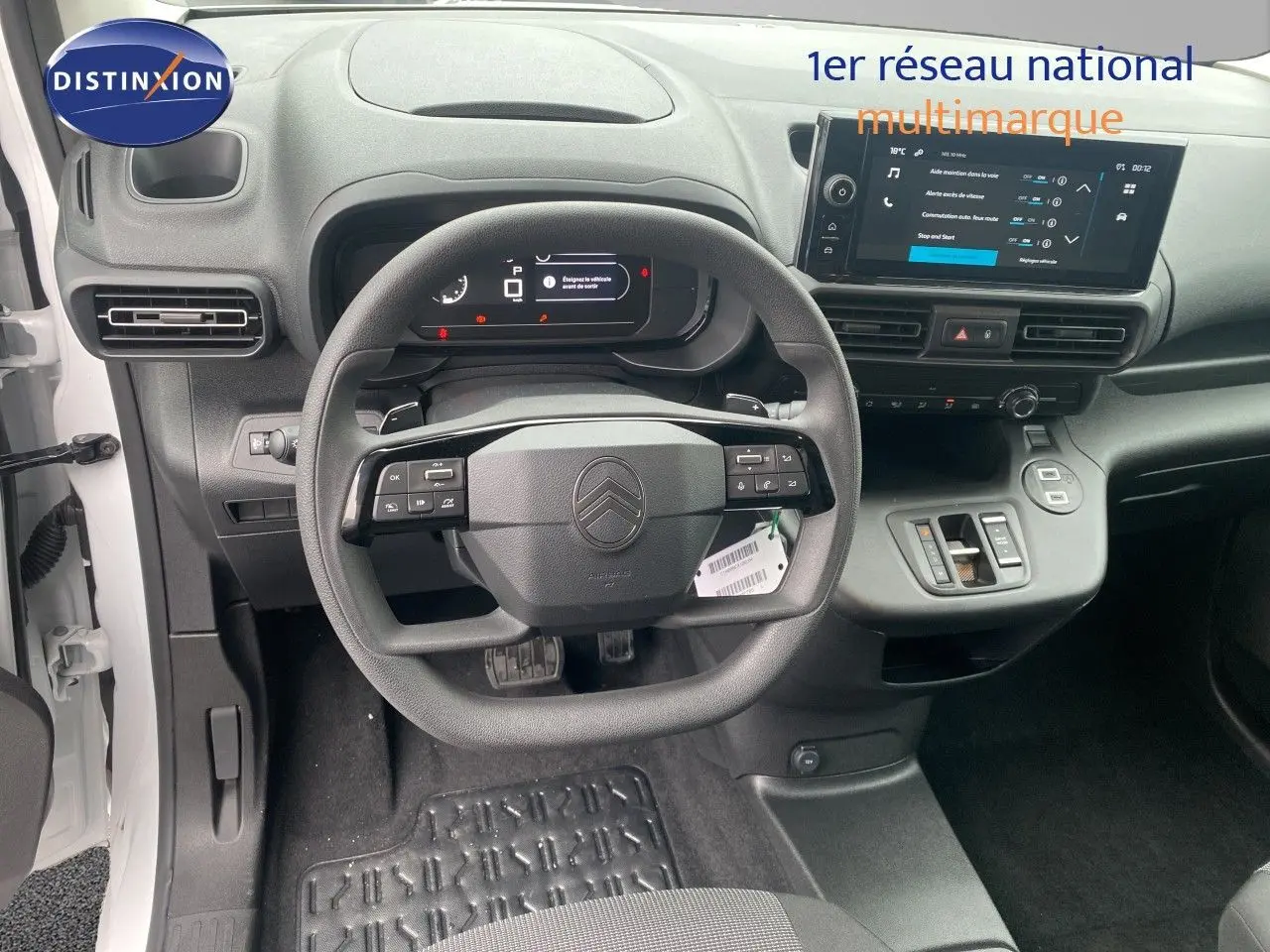 Vue intérieure frontale du tableau de bord du Citroën Berlingo Fourgon blanc 2025 avec volant multifonction et écran tactile.