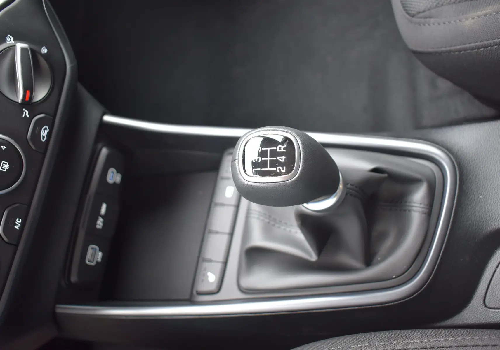 Gros plan sur le levier de vitesses manuel noir et cuir de la Hyundai i20 1.2 79 Intuitive 2025.