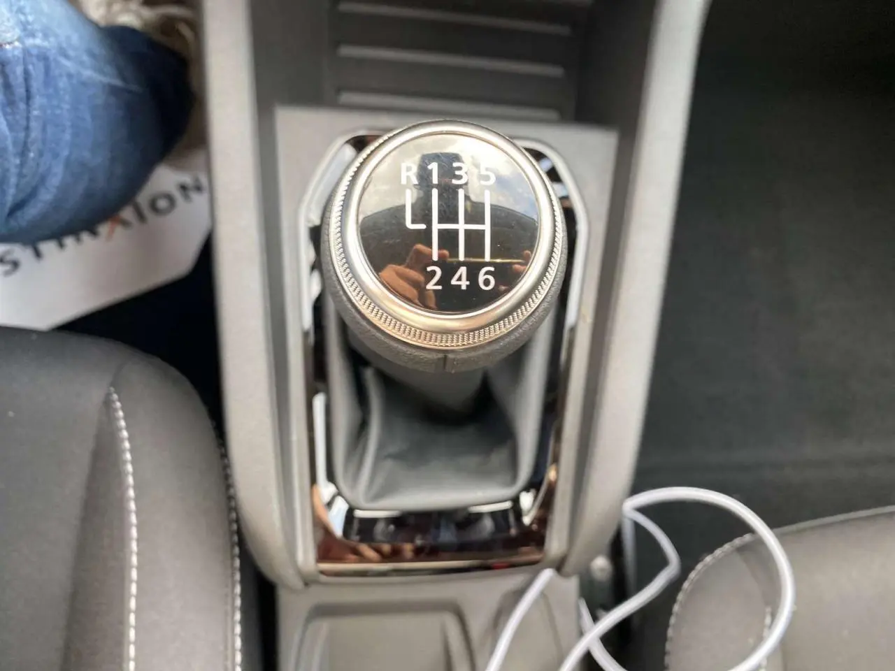 Le levier de vitesses manuel de la Renault Clio 2025 en gros plan, avec coutures blanches sur la console centrale.