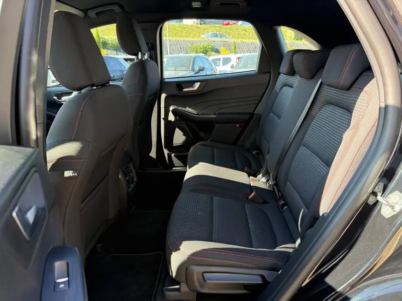 Vue intérieure côté droit des sièges arrière noirs avec surpiqûres rouges du Ford Kuga 2.0 EcoBlue 2024.