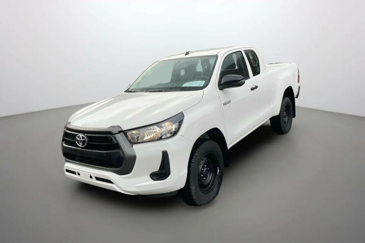 Toyota Hilux 4x4 blanc pur vu en 3/4 avant droit, avec calandre noire et jantes acier noires.