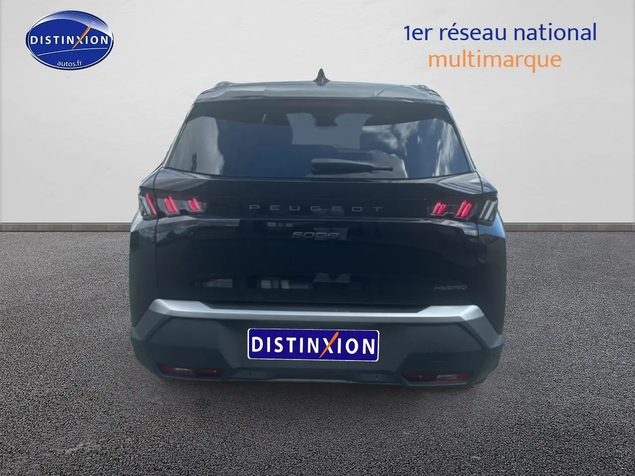 Vue arrière d’un Peugeot 5008 noir avec feux arrière LED et logo distinctif sur fond neutre.