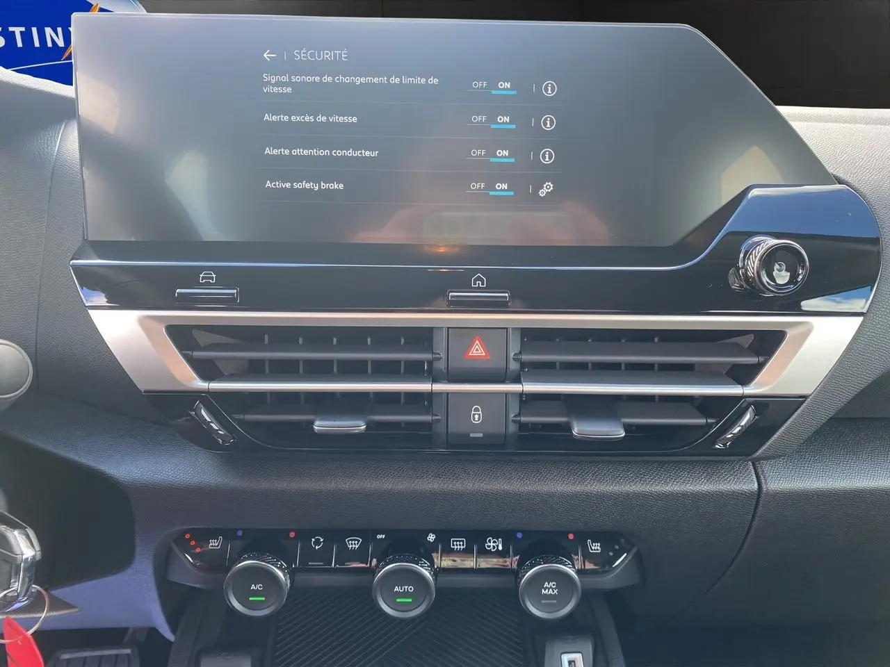 Détail du tableau de bord de la Citroën C4 hybride 2025 montrant l'écran tactile et les commandes de climatisation.