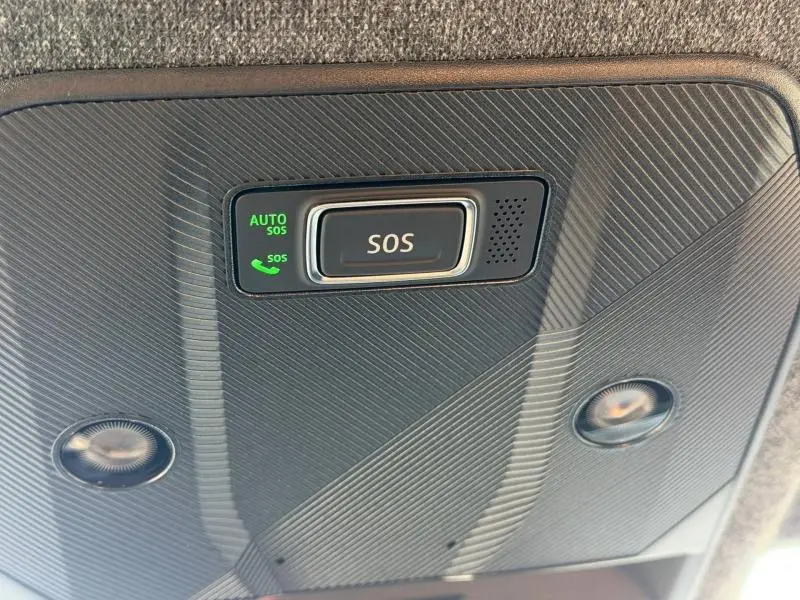 Vue en gros plan du bouton SOS lumineux intégré au plafond intérieur du Renault Scenic E-Tech Electric blanc 2025.