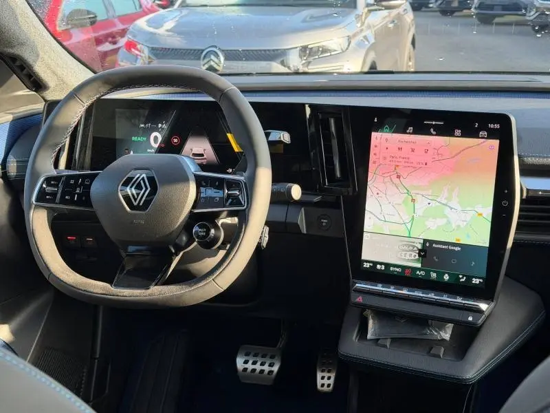 Vue intérieure du tableau de bord et volant du Renault Scénic E-Tech blanc 2025 avec écran tactile vertical et affichage numérique.