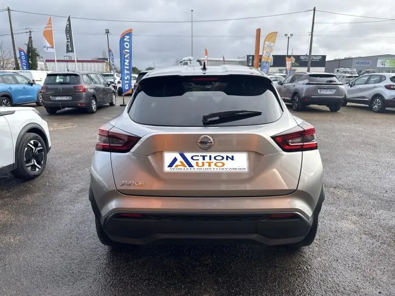 Vue arrière d'un Nissan Juke gris perle métallisé 2022 garé en extérieur sur un parking de concession.