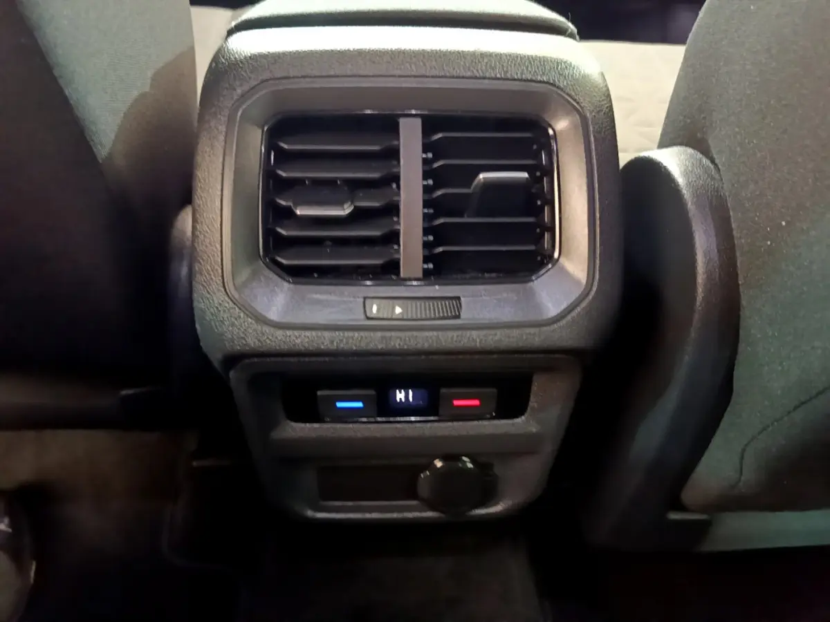 Vue rapprochée des aérateurs arrière et commandes de climatisation digitale du Volkswagen Tiguan noir 2021.