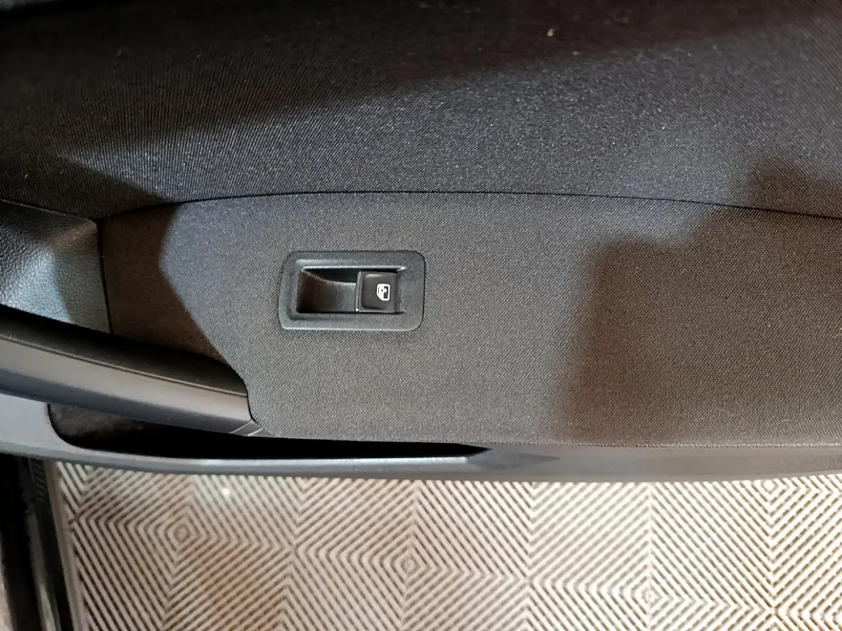 Détail de la commande de verrouillage de porte sur la garniture intérieure noire d'une Volkswagen Tiguan 2021.