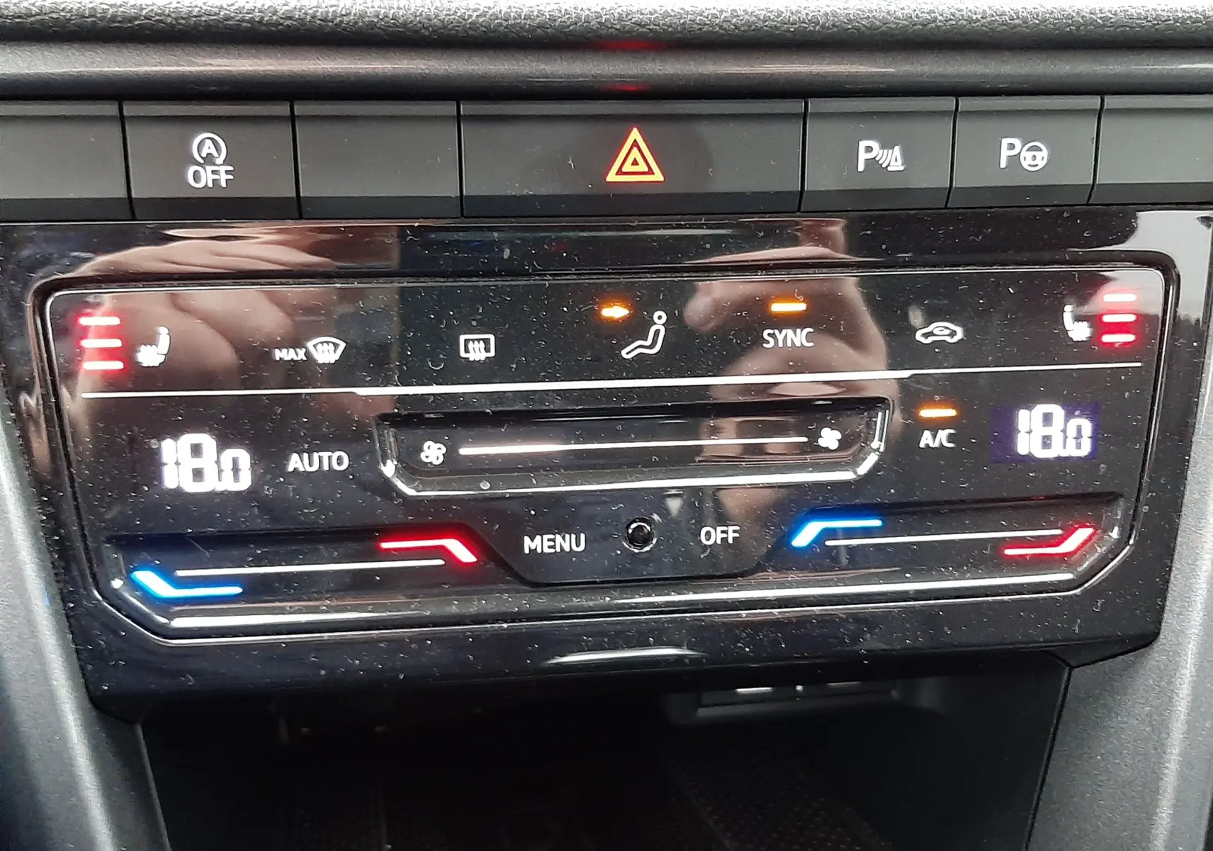 Gros plan sur la console centrale du Volkswagen T-Roc 2023, montrant les ports USB-C et un bouton allume-cigare.