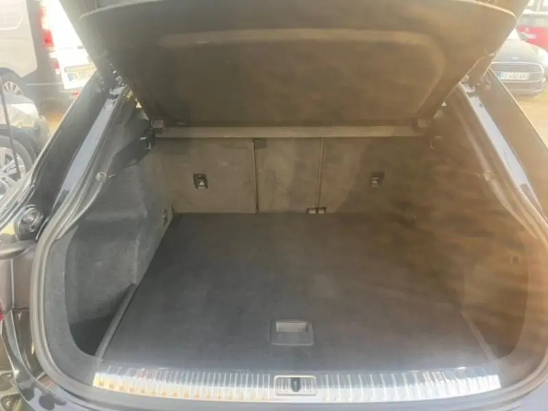 Vue intérieure du coffre ouvert noir Mythic de l'Audi RS Q3 Sportback 2020, montrant un espace de chargement spacieux et propre.