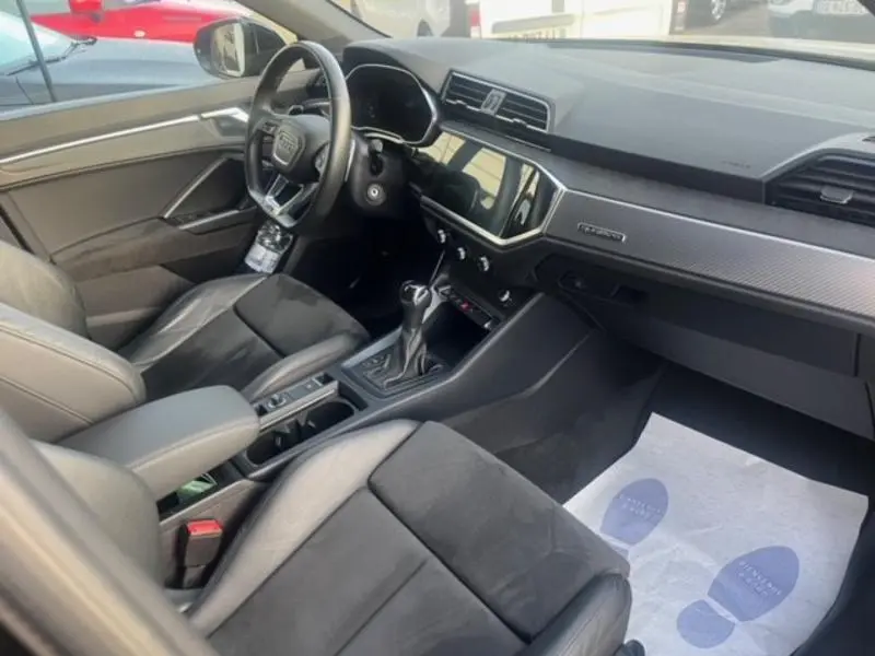 Intérieur noir de l'Audi RS Q3 Sportback 2020 vu côté conducteur, avec volant cuir multifonction et écran tactile central.