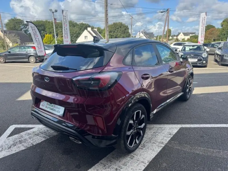 Ford Puma 2023 rouge Vivid Ruby en 3/4 arrière droit avec toit noir et jantes alu noires brillantes