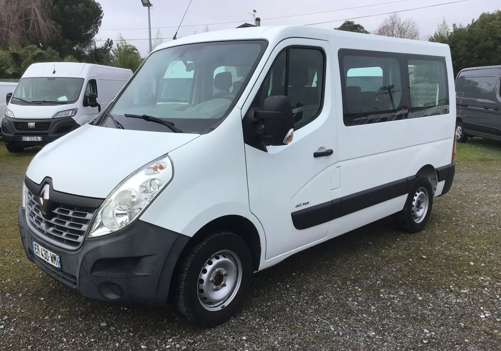 Renault Master Combi III blanc en vue 3/4 avant droit, fourgon utilitaire avec vitres latérales teintées.