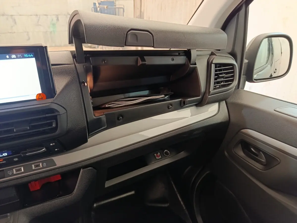 Intérieur du Peugeot Expert Fourgon XL Diesel 2026, vue côté passager avec boîte à gants ouverte et tableau de bord noir et gris.