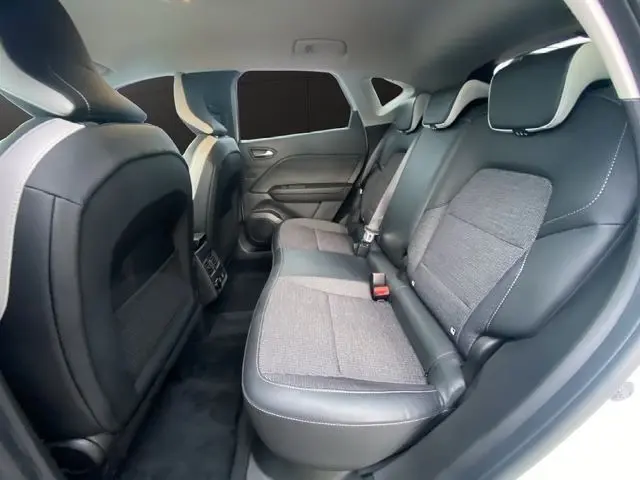 Vue intérieure arrière côté droit du Renault Captur 2021, sièges bicolores cuir et tissu gris avec surpiqûres blanches.