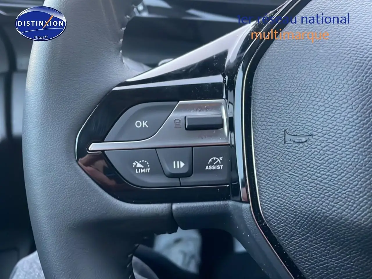 Gros plan sur les commandes gauche du volant noir du Peugeot 308 1.2 hybrid 145 allure e-dcs6, finition 2025.